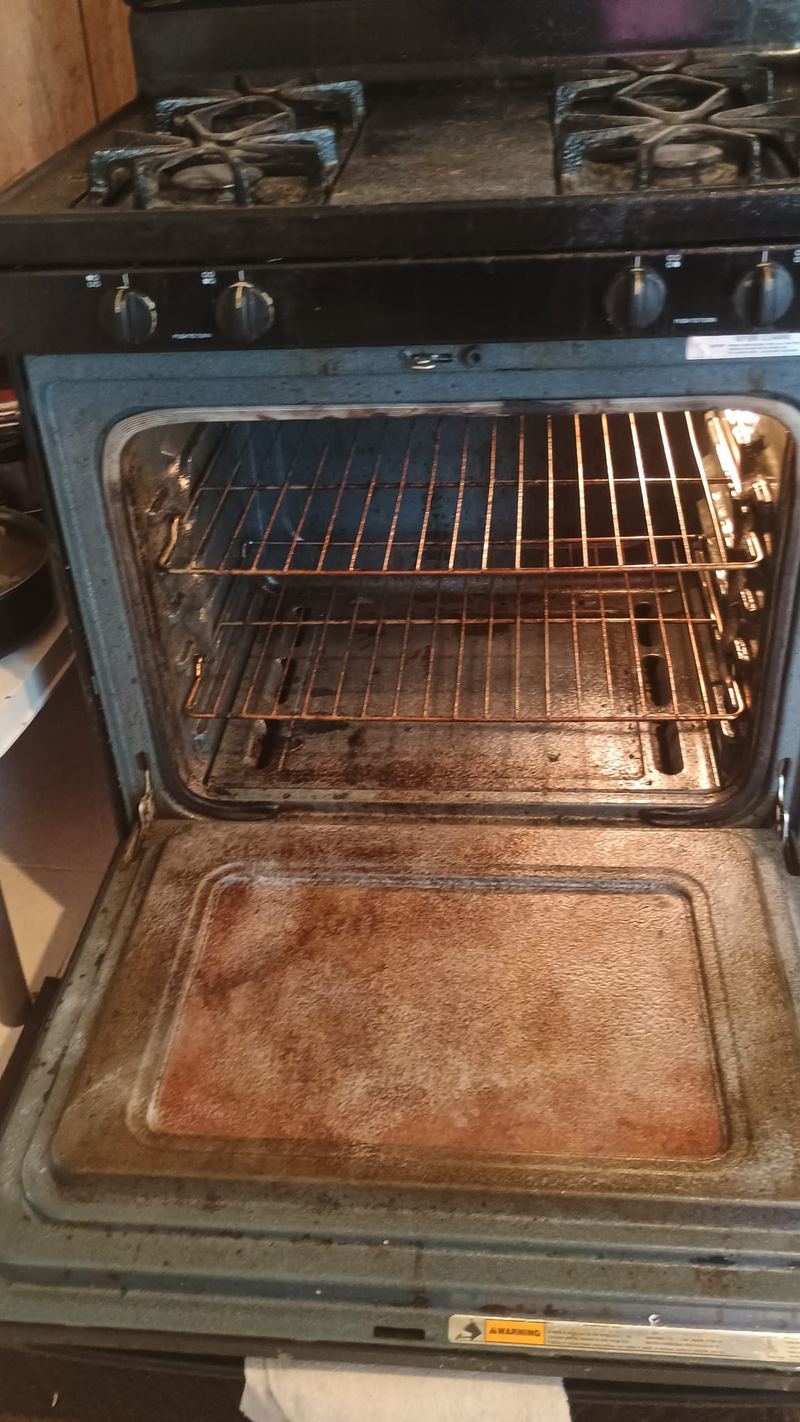 Greasy, burnt-on oven interior before cleaning